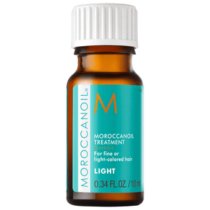 Small amber bottle of Moroccanoil Treatment Light - Mini Travel | Moroccanoil with turquoise label, designed for fine or light-colored hair in skincare and hair care wellness.