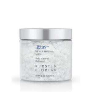 Clear jar of coarse white bath salts labeled Mineral Wellness Soak | Kerstin Florian with a silver lid, designed for skincare and body care wellness routines.