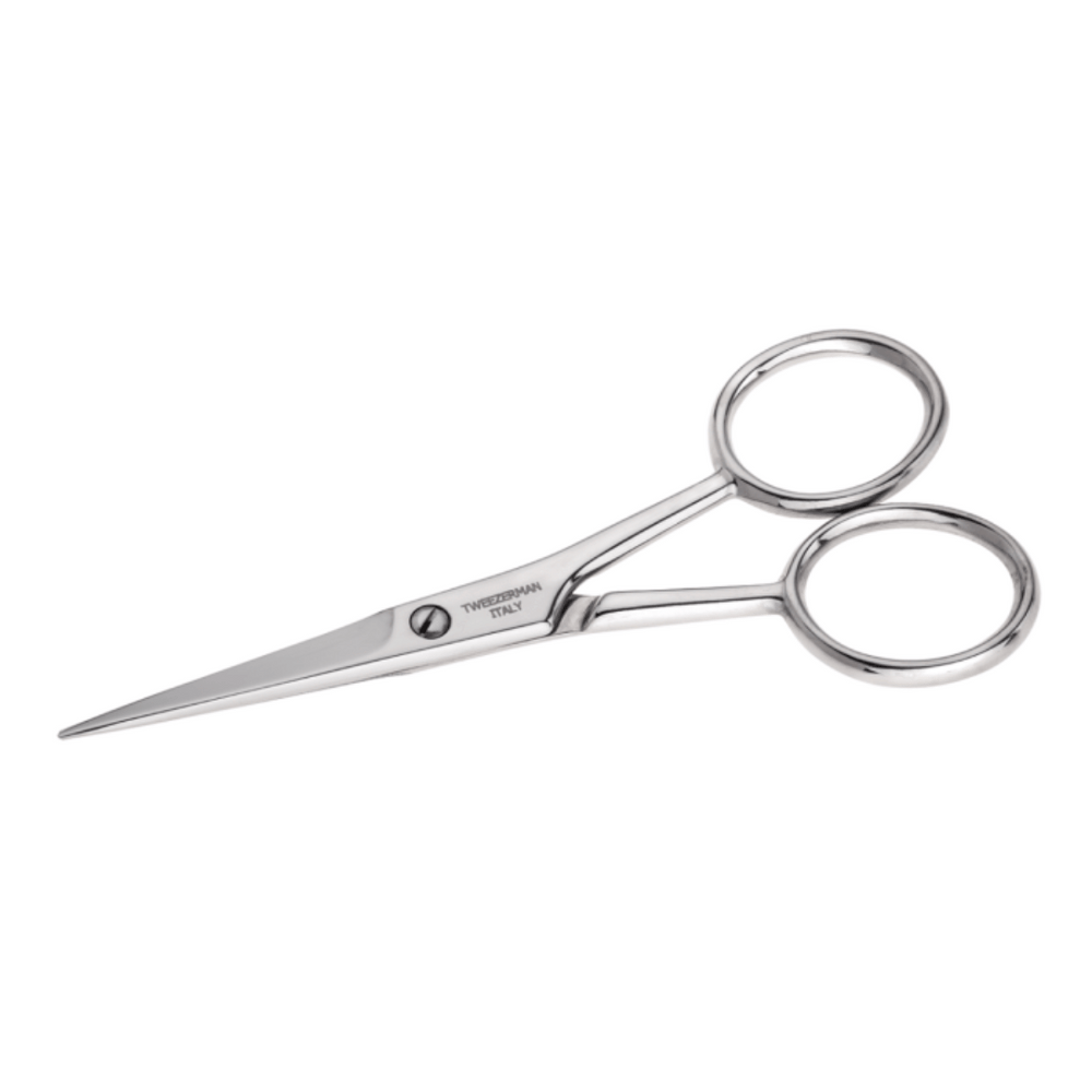 Close-up of shiny stainless steel moustache scissors with slim, pointed blades and round finger holes from Moustache Scissors & Comb | Tweezerman set.