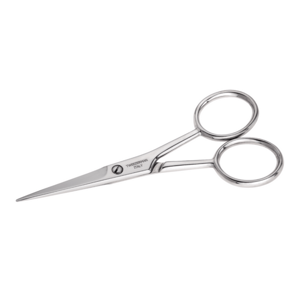 Close-up of shiny stainless steel moustache scissors with slim, pointed blades and round finger holes from Moustache Scissors & Comb | Tweezerman set.