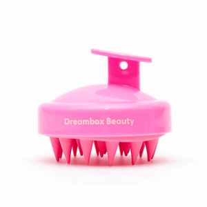Bright pink scalp massager with soft silicone bristles and handle, designed for gentle exfoliation and stimulation, Scalp Scrubber [Revitalizing Scalp Massager] | Dreambox Beauty.