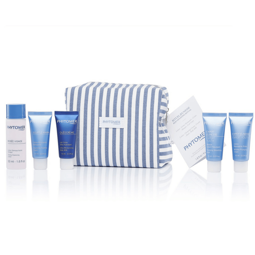 Age Solution Travel Set | Phytomer featuring six blue and white skincare products with a striped blue and white travel pouch for convenient on-the-go body care and wellness.