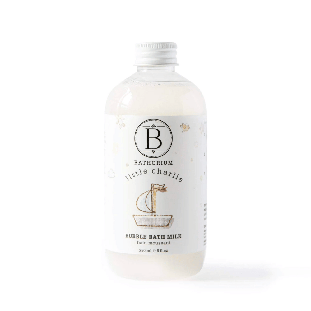 Clear bottle of little charlie™ Bubble Bath Milk | Bathorium with white cap and minimalistic label featuring a small sailboat illustration, designed for skincare and body care.