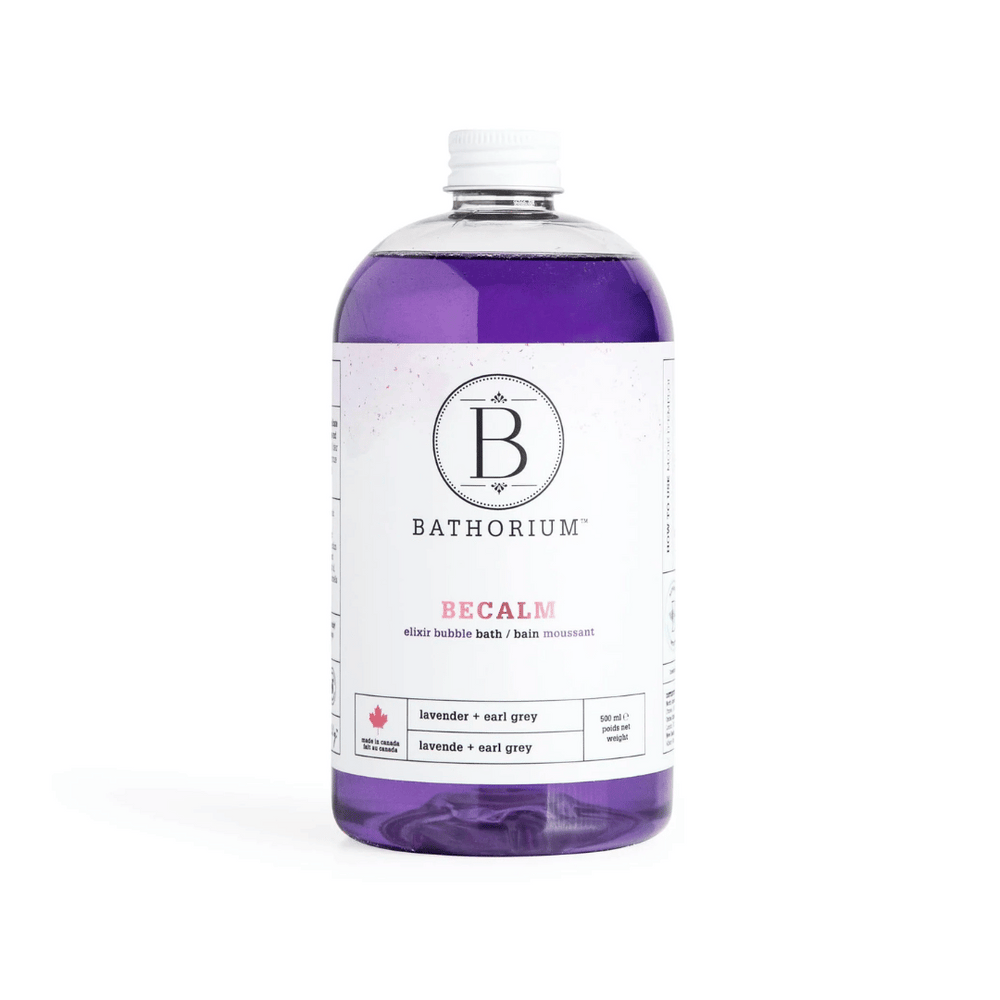 Clear bottle of BeCalm Bubble Elixir | Bathorium with purple lavender and earl grey bath elixir inside on a white background, promoting relaxation and wellness skincare.