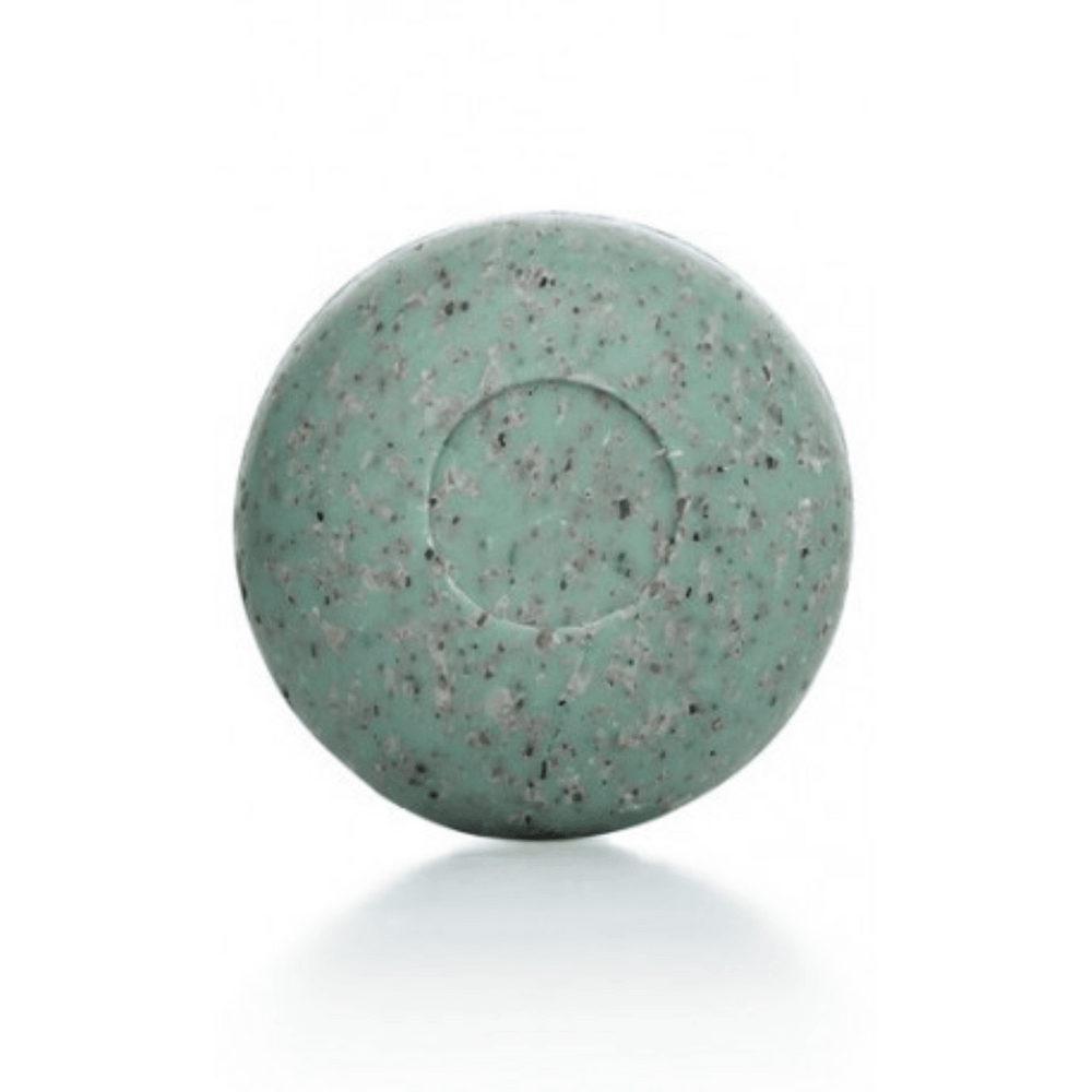 Round green speckled bar of Seaweed Soap | Phytomer on a white background, designed for skincare and body care use.