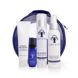 Set of four skincare products including cleanser, serum, brightener, and mist in white and blue packaging with purple cosmetic bag for Pigmentation Regimen Bundle | Circadia