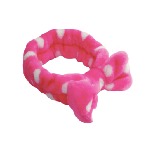 Bright pink and white polka dot plush spa headband with a bow, soft and comfortable for skincare and wellness routines, from Spa Headbands | Live Love Spa.
