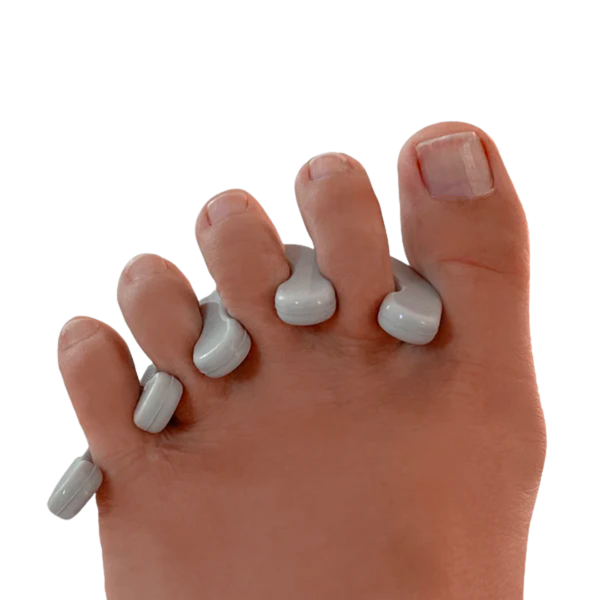 Close-up of a foot with gray toe separators placed between each toe, demonstrating the Spaced Out | Barefoot Scientist product for foot wellness and recovery.
