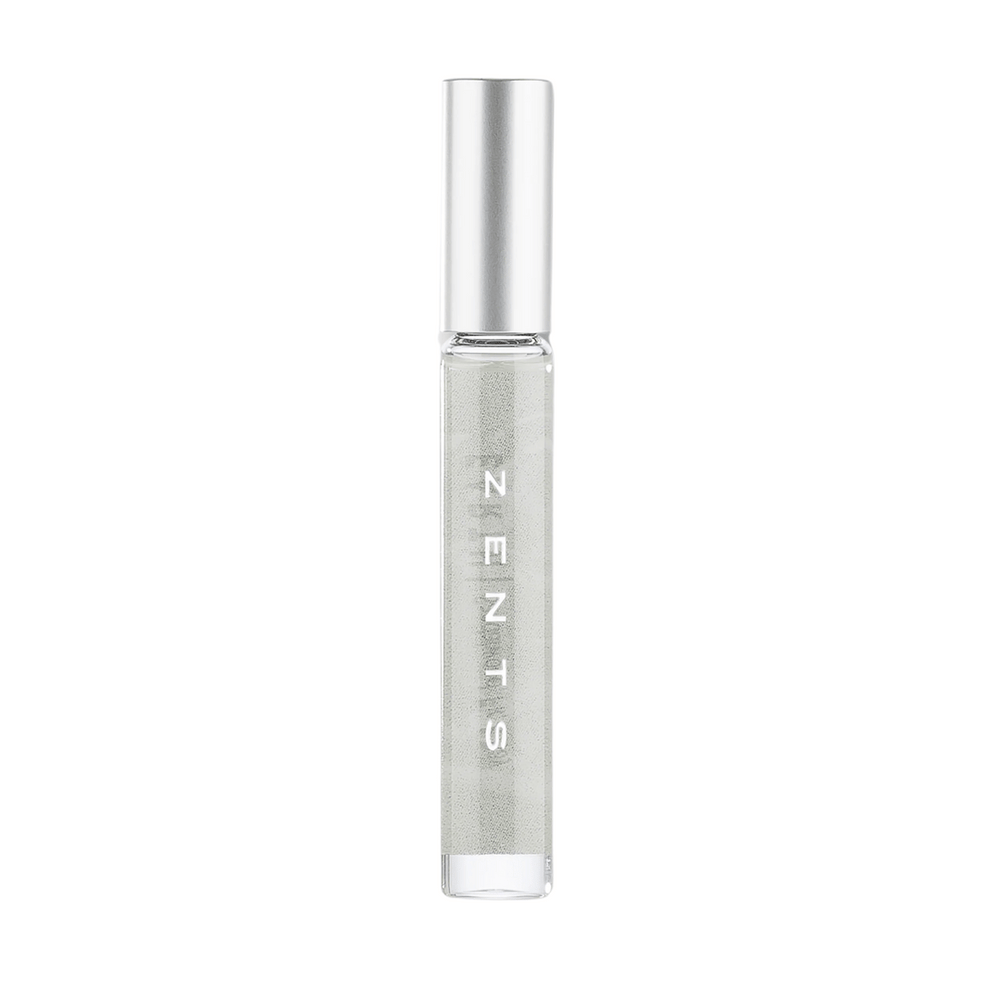 Clear glass roll-on bottle with silver cap containing a light-colored liquid, labeled with "ZENTS," representing the Attar Roll-on Scent | Zents for personal wellness and body care.