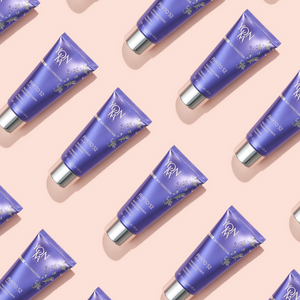 Multiple tubes of Phyto 52 Crème - Firming, Anti-Aging, Revitalizing I Yon-Ka Paris displayed in a repeating pattern on a soft pink background, highlighting skincare packaging.