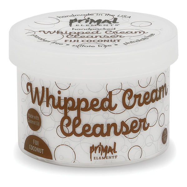 Fiji Coconut Whipped Cream Cleanser | Primal Elements in a white round container with brown text highlighting coconut oil ingredients, designed for skincare and body care.