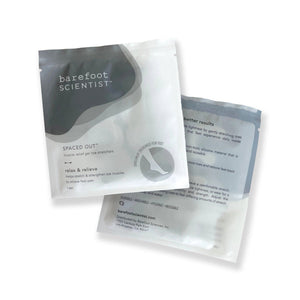 Two white and gray resealable pouches of Spaced Out | Barefoot Scientist muscle relief gel toe stretchers designed to relax and relieve foot pain by stretching and strengthening toes.
