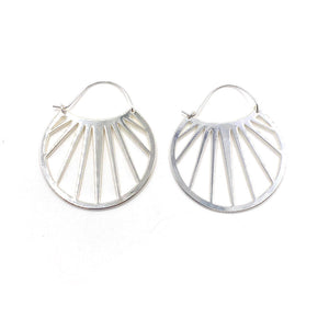 Pair of silver metal openwork hoop earrings with a geometric sunray design, styled as Bali Hoops | Purpose Jewelry.