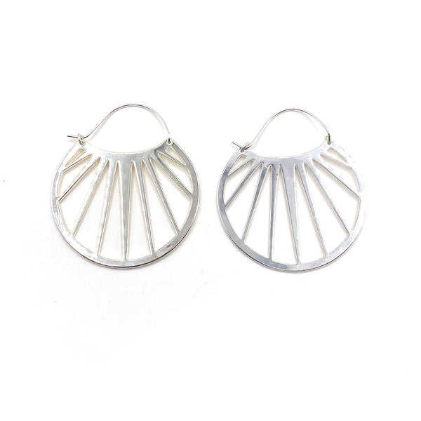 Pair of silver metal openwork hoop earrings with a geometric sunray design, styled as Bali Hoops | Purpose Jewelry.