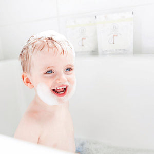 Child with bubbles on face and head enjoying a bath, showcasing the use of little charlie™ Kids Bath Soak 750g | Bathorium for gentle skincare and body care.