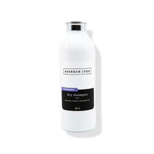 White bottle of Dry Shampoo | Essence One in lavender scent with minimalist label design showcasing natural and therapeutic qualities for hair care.