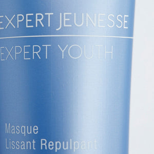 Close-up of a smooth blue skincare tube labeled Expert Youth Mask | Phytomer, highlighting refined texture and premium packaging for skincare and wellness use.