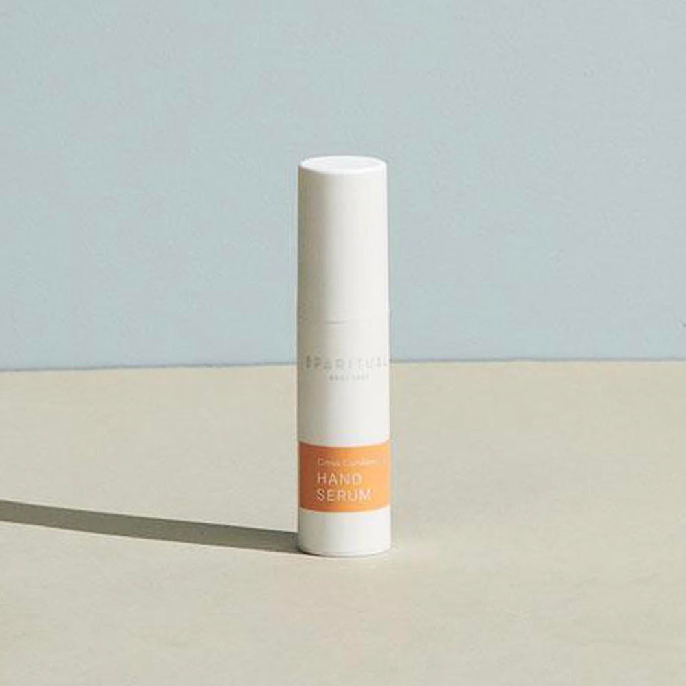 Minimalist white bottle of Citrus Cardamom HAND SERUM | Sparitual with soft natural lighting, ideal for skincare and body care wellness routines.
