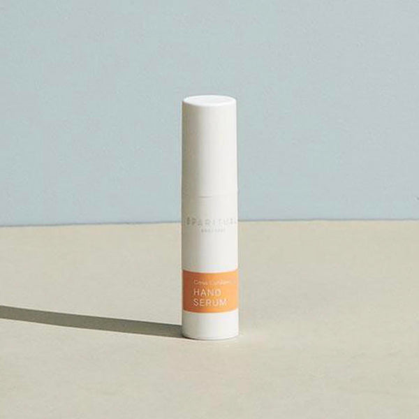 Minimalist white bottle of Citrus Cardamom HAND SERUM | Sparitual with soft natural lighting, ideal for skincare and body care wellness routines.