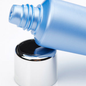 Close-up of a blue tube dispensing Hydrasea Mask | Phytomer skincare product with a shiny silver cap, highlighting its smooth texture and spa-inspired design.