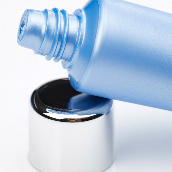 Close-up of a blue tube dispensing Hydrasea Mask | Phytomer skincare product with a shiny silver cap, highlighting its smooth texture and spa-inspired design.