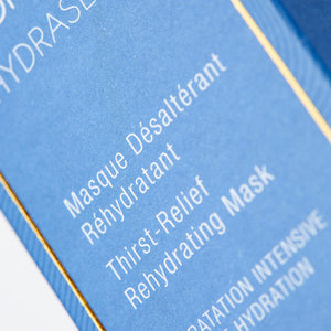 Close-up of blue packaging displaying text describing a thirst-relief rehydrating skincare product, Hydrasea Mask | Phytomer, emphasizing intensive hydration and skincare benefits.