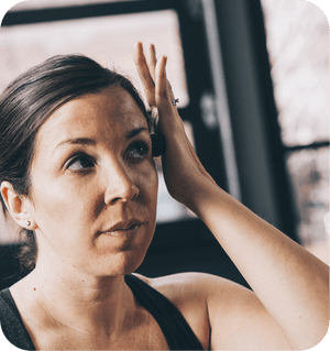 Woman using Micro Rounds | RAD pressing around her temple area in a calm, wellness-focused skincare and body care routine.