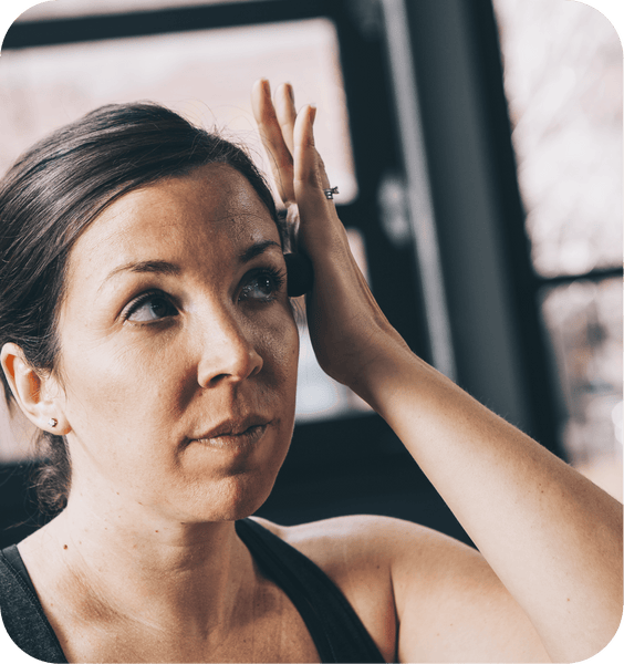Woman using Micro Rounds | RAD pressing around her temple area in a calm, wellness-focused skincare and body care routine.