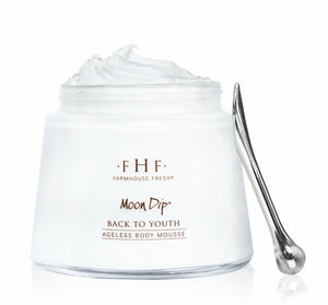 Jar of Moon Dip Back To Youth Ageless Body Mousse | Farmhouse Fresh with a whipped white mousse texture and a small metal spatula for skincare and body care application.