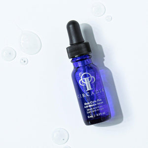 Blue glass dropper bottle of Myo-Cyte Plus | Circadia anti-wrinkle serum with clear serum droplets on a white surface, showcasing skincare product for skin renewal.
