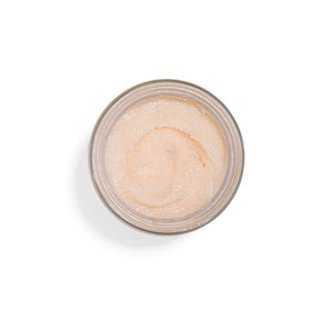 Open jar of One Fine Day Flawless Face Polish | Farmhouse Fresh showing light peach-colored exfoliating skincare product with smooth creamy texture.