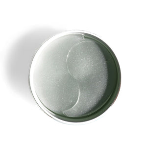 Close-up overhead view of translucent gel eye patches arranged in a circular container for skincare, showcasing FLASHPATCH® REJUVENATING EYE GELS | Patchology designed for eye area rejuvenation and wellness.