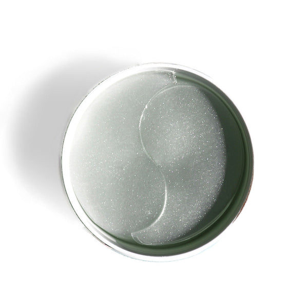 Close-up overhead view of translucent gel eye patches arranged in a circular container for skincare, showcasing FLASHPATCH® REJUVENATING EYE GELS | Patchology designed for eye area rejuvenation and wellness.