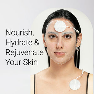 Woman wearing a restorative facial sheet mask with attached electrode pads for skin hydration and rejuvenation, promoting skincare with Restorative Facial Sheet Mask Set - 2 Mask Kit | 7e Wellness.