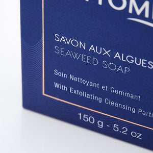 Close-up of blue packaging for Seaweed Soap | Phytomer featuring French and English text highlighting exfoliating cleansing properties and product weight.