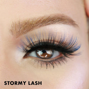 Close-up of a brown eye with long, voluminous black and blue lashes showcasing Stormy Lash - Colored | Moxielash for a bold and dramatic look.