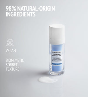 Hydramemory Water Source Serum | [ comfort zone ] in a clear bottle with white cap, shown with creamy serum texture on a light background emphasizing natural-origin ingredients and vegan formula.